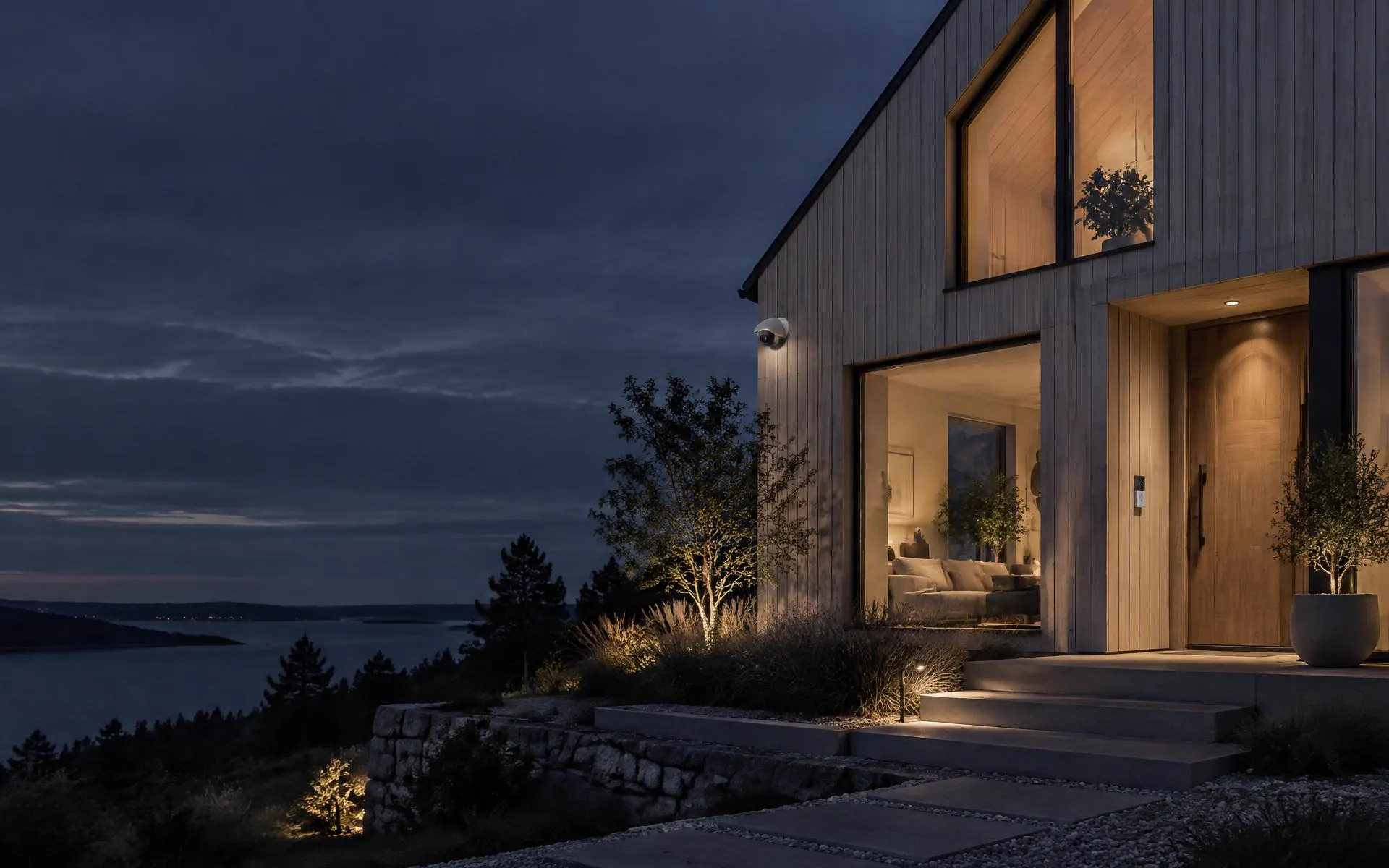 Nordic home at dusk with warm entrance lighting and discreet security devices